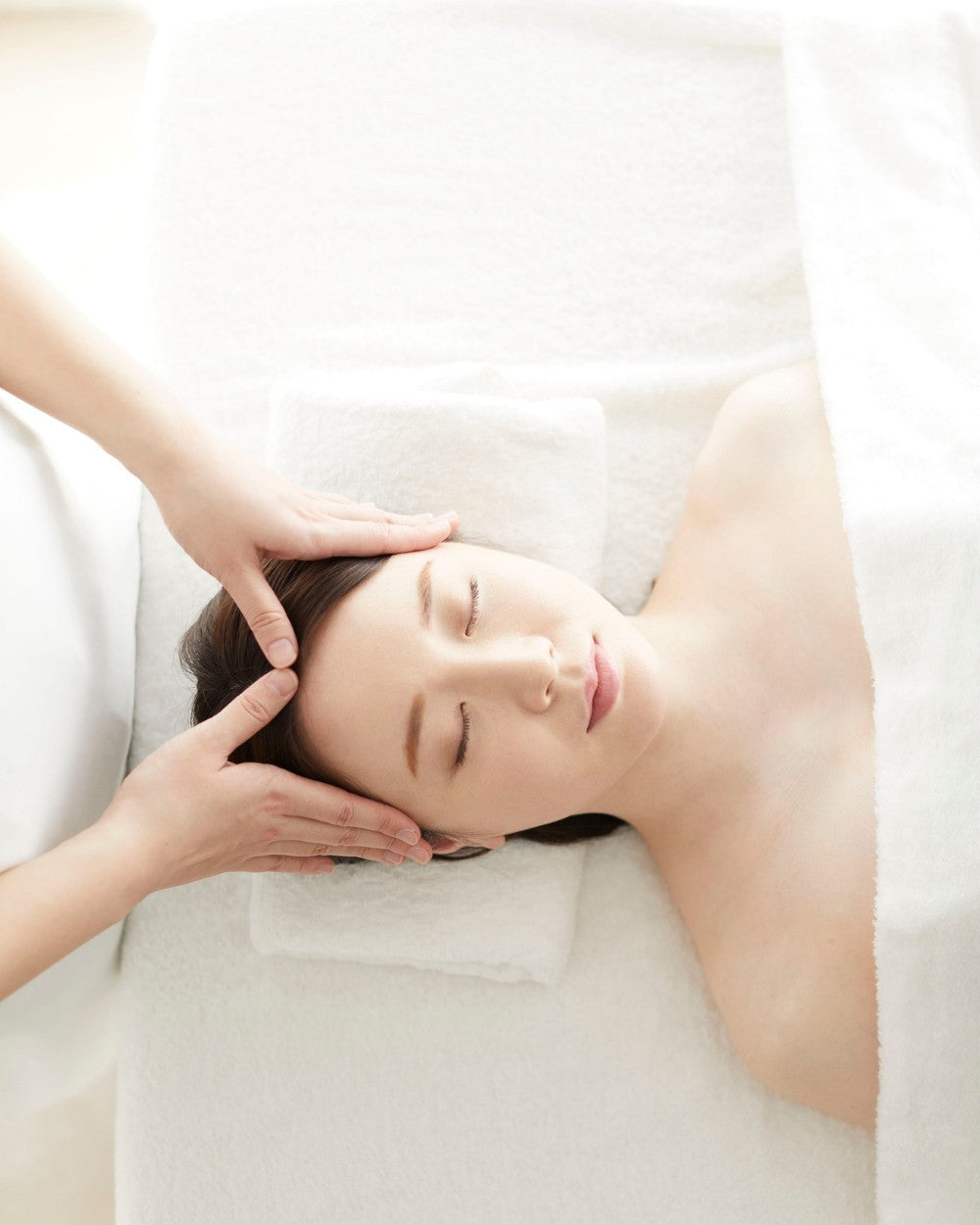 Therapist performing a Korean head massage